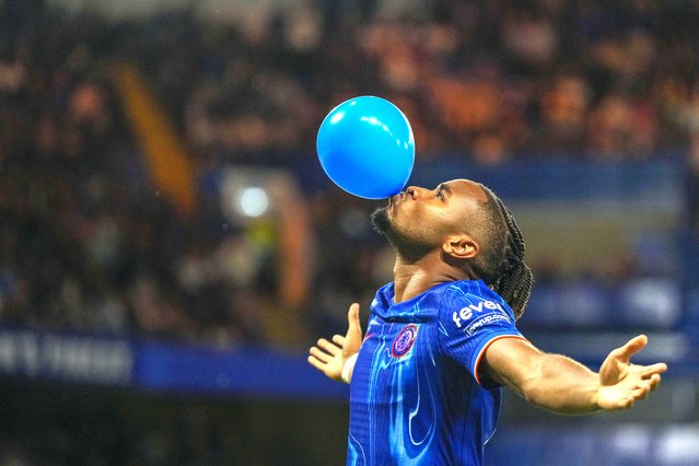 Chelsea's Christopher Nkunku celebrates after scoring his side's opening goal from a penalty spot during the Europa Conference League play-off first leg soccer match between Chelsea and Servette, at Stamford Bridge stadium in London, Thursday, August 22, 2024. (Photo by Alastair Grant/AP Photo)