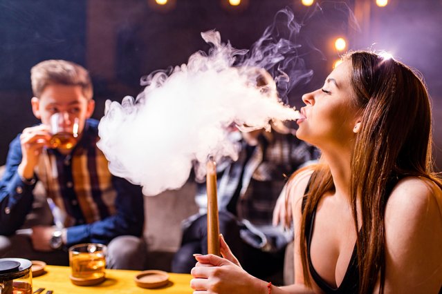 Friends party in hookah lounge smoking shisha night time. (Photo by Alamy Stock Photo)