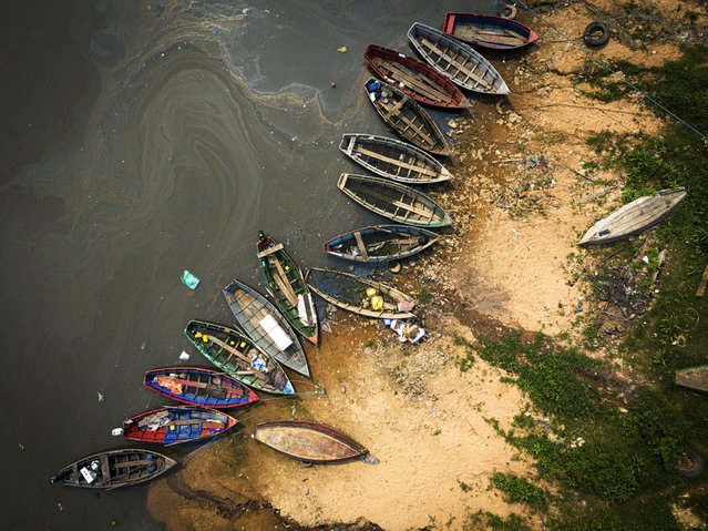 Fishing boats sit on the shore of the Paraguay River in Mariano Roque Alonso, Paraguay, Monday, September 9, 2024. Water levels have plunged to their lowest-ever level amid a drought, according to Paraguay's Meteorology and Hydrology Office. (Photo by Jorge Saenz/AP Photo)