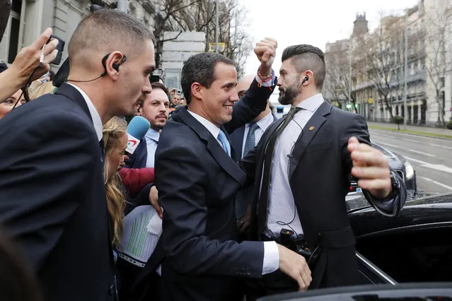 The leader of Venezuela's political opposition Juan Guaido waves during a visit to Madrid, Spain, Saturday, January 25, 2020. Juan Guaido, the man who one year ago launched a bid to oust Venezuelan President Nicolas Maduro, arrived Saturday in Spain, where a thriving community of Venezuelans and a storm among Spanish political parties awaited him. (Photo by Paul White/AP Photo)