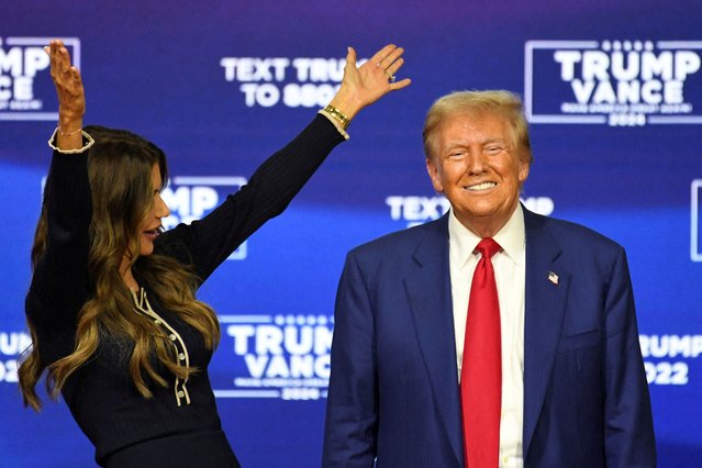 Republican presidential nominee former U.S. President Donald Trump smiles as South Dakota Governor Kristi Noem gestures during a town hall campaign event in Oaks, Pennsylvania on October 15, 2024. (Photo by David Muse/Reuters)