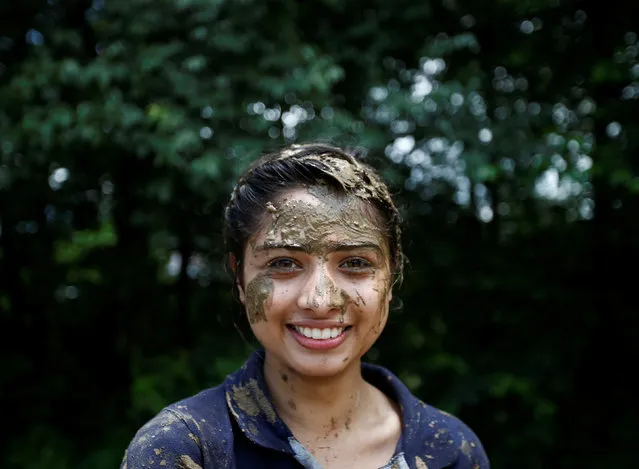 A student of Himalayan Agriculture College with mud on her face poses for a picture while celebrating Asar Pandra festival in Lalitpur, Nepal, June 29, 2016. (Photo by Navesh Chitrakar/Reuters)
