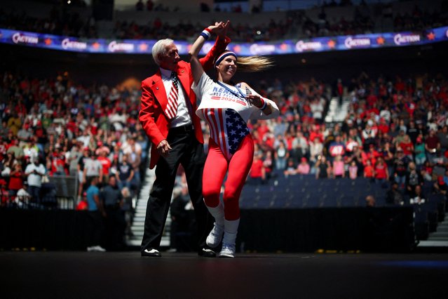 Supporters of Republican presidential nominee and former U.S. President Donald Trump dance during a campaign event sponsored by conservative group Turning Point USA, in Duluth, Georgia on October 23, 2024. (Photo by Carlos Barria/Reuters)