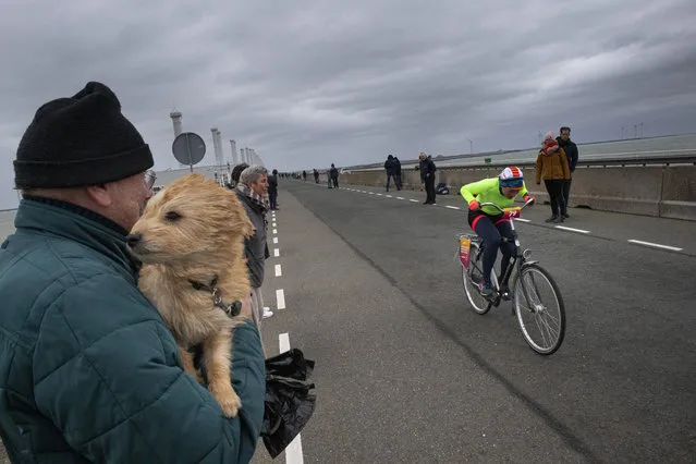 A competitor battles gale force winds during the Dutch Headwind Cycling Championships on the storm barrier Oosterscheldekering near Neeltje Jans, south-western Netherlands, Sunday, February 9, 2020. (Photo by Peter Dejong/AP Photo)