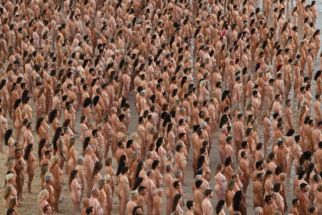 Thousands of people stand nude, as part of an installation by contemporary artist Spencer Tunick, at Bondi Beach in Sydney, Australia 26 November 2022. Thousands of people have bared all for photographer Spencer Tunick at Sydney's Bondi Beach. The shoot aims to remind people to get checked for skin cancer. (Photo by Dean Lewins/EPA/EFE)