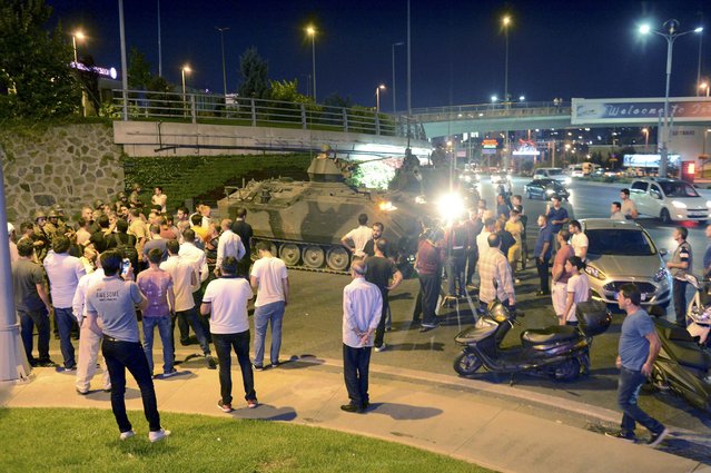 A crowd surrounds Turkish armoured vehicles near Ataturk airport in Istanbul, Turkey July 16, 2016. (Photo by Reuters/IHLAS News Agency)