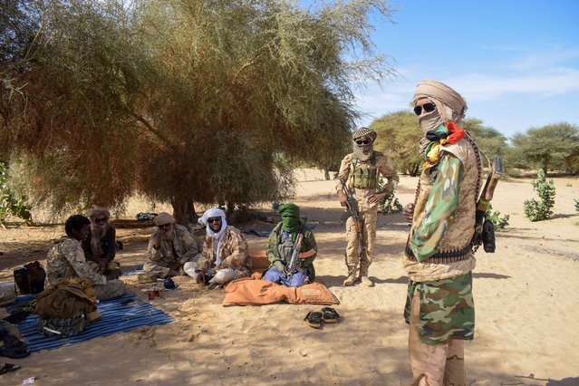 Fighters from Permanent Strategic Framework for the Defense of the People of Azawad (CSP-DPA) gather as they secure the perimeter during a meeting of Tuareg rebels army leaders in Tinzaouaten, Northern Mali on November 27, 2024. (Photo by Abdolah Ag Mohamed/Reuters)