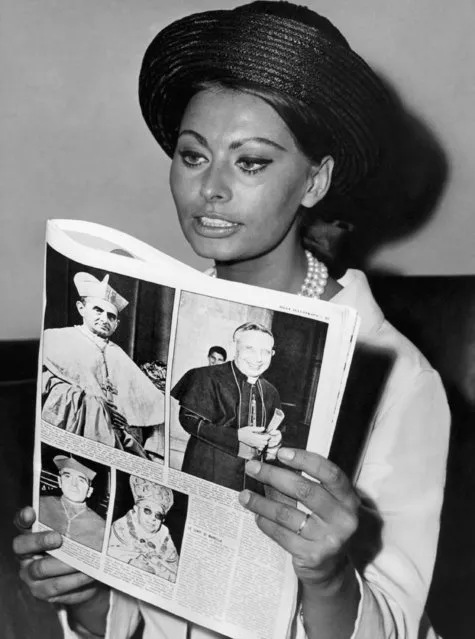 Italian movie star Sophia Loren sits reading a magazine carrying an article about the current Conclave for the election of a successor to the late Pope John XXIII, in Rome, June 21, 1963 at the headquarters of the association of Italian movie producers. Cardinals shown in magazine pictures are, top row only, Giovanni Battista Cardinal Montini, Archbishop of Milan, who later that same day was elected Pope and took the name Paul VI (left). Right is Giacomo Cardinal Lercaro, Archbishop of Bologna, who also was a very strong candidate to Papacy. (Photo by AP Photo)