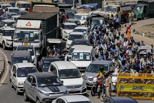 Vehicles queue in a long traffic jam at Delhi-Ghaziabad border after local authorities stopped vehicular movement except for essential services during an extended lockdown to slow the spreading of the coronavirus disease (COVID-19) in New Delhi, India, April 21, 2020. (Photo by Adnan Abidi/Reuters)