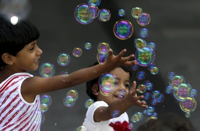 Migrant children play with bubbles at Keleti railway station in Budapest, Hungary, September 6, 2015. (Photo by David W. Cerny/Reuters)