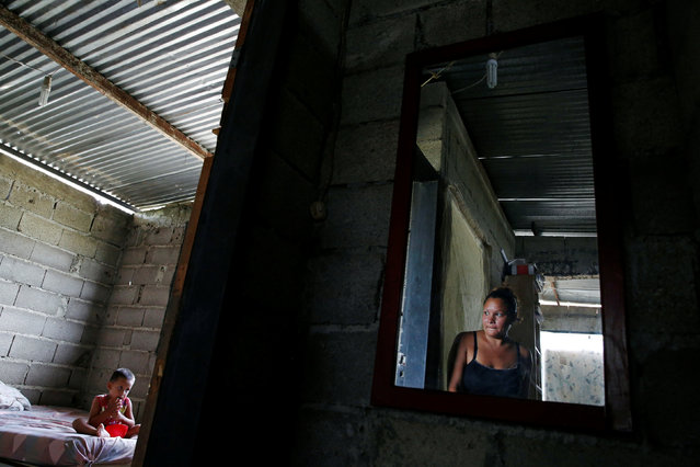 Venezuela's food shortages, inflation and crumbling medical sector have become such a source of anguish that a growing number of young women are reluctantly opting for sterilizations rather than face the hardship of pregnancy and child-rearing. Traditional contraceptives like condoms or birth control pills have virtually vanished from store shelves, pushing women towards the hard-to-reverse surgery. While no recent national statistics on sterilizations are available, doctors and health workers say demand for the procedure is growing. Here: Oleydy Canizalez (R), 29, looks at her son Luis, 3, while he eats lunch, before her sterilization surgery, at their home in Charallave, Venezuela July 7, 2016. (Photo by Carlos Garcia Rawlins/Reuters)