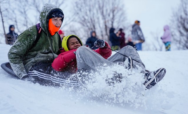 Braedyn Ruyle (left) and Cam slide down a hill together at Garfield Park in Indianapolis on January 6, 2025. (Photo by USA Today)