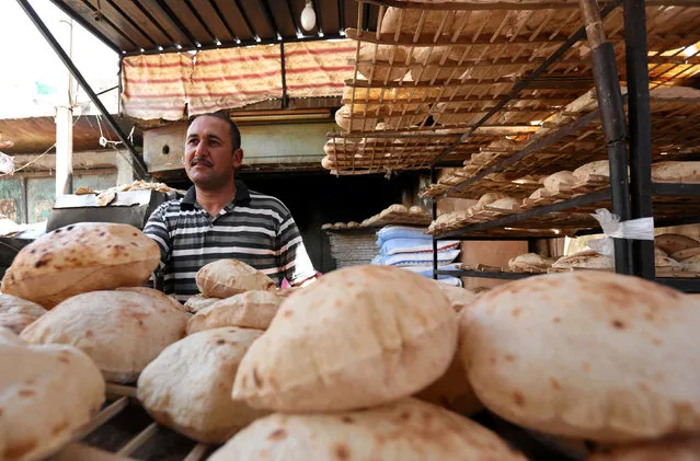 An Egyptian baker is seen beside a vegetable market in Cairo, Egypt, June 15, 2016. Picture taken June 15, 2016. (Photo by Mohamed Abd El Ghany/Reuters)