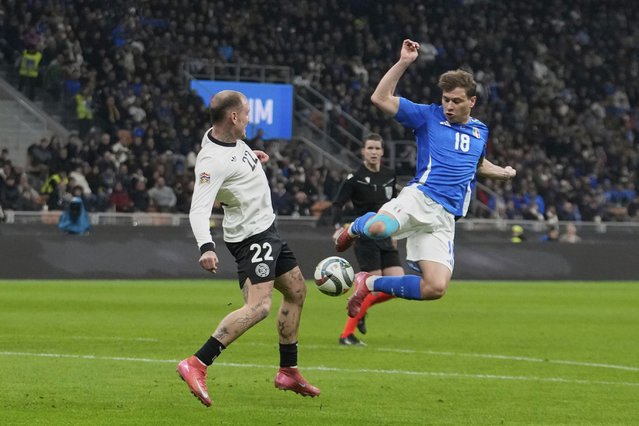Germany's David Raum, left, fights for the ball with Italy's Nicolo Barella during the soccer Nations League quarterfinal first leg soccer match between Italy and Germany, at the San Siro stadium in Milan, Italy, Thursday, March 20, 2025. (Photo by Luca Bruno/AP Photo)