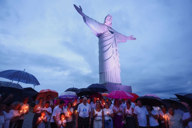 People attend a prayer service near the Christ the Protector statue, while Pope Francis continues his hospitalization, in Encantado, state of Rio Grande do Sul, Brazil on February 27, 2025. (Photo by Diego Vara/Reuters)