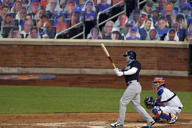 New York Yankees' Clint Frazier, left, watches his two-run home run against the New York Mets during the fourth inning of a baseball spring training game Saturday, July 18, 2020, in New York. (Photo by Adam Hunger/AP Photo)