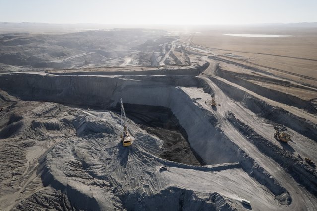 This aerial photo taken on February 21, 2025 shows vehicles transferring coal at a coal mine in Ulaanbaatar, the capital of Mongolia. The toxic smog that settles over the Mongolian capital every winter has been a suffocating problem for well over a decade that successive governments have failed to dispel. (Photo by Jade Gao/AFP Photo)