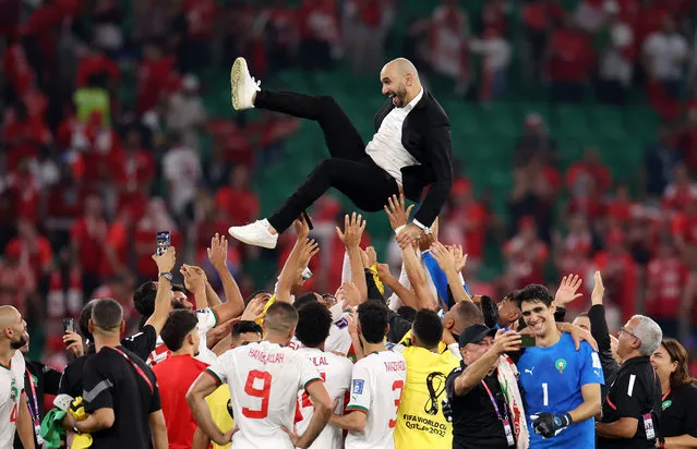 Walid Regragui, Head Coach of Morocco, celebrates with the team after their qualification to the knockout stages during the FIFA World Cup Qatar 2022 Group F match between Canada and Morocco at Al Thumama Stadium on December 01, 2022 in Doha, Qatar. (Photo by Catherine Ivill/Getty Images)