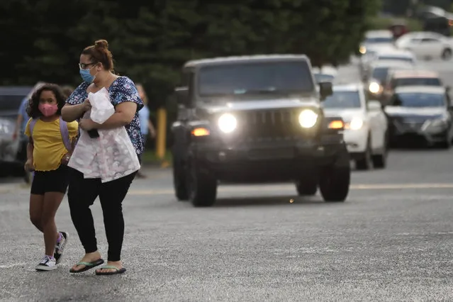 Students arrive to Dallas Elementary School for the first day of school amid the coronavirus outbreak on Monday, August 3, 2020, in Dallas, Ga. (Photo by Brynn Anderson/AP Photo)