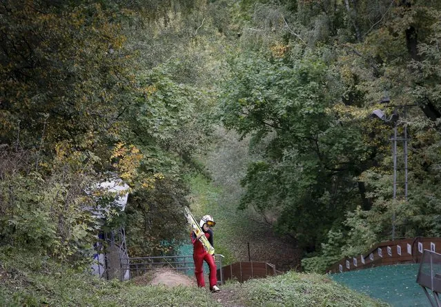 A young skier carries his skis through an autumn park near a ski jump complex in Moscow, Russia, September 20, 2015. (Photo by Maxim Shemetov/Reuters)