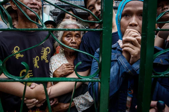 Indonesian Muslims queue outside the gate of to Margoyuono mosque to get a share of the sacrificial meat at during celebrations for Eid al-Adha on September 12, 2016 in Yogyakarta, Indonesia. Muslims worldwide celebrate Eid Al-Adha, to commemorate the Prophet Ibrahim's readiness to sacrifice his son as a sign of his obedience to God, during which they sacrifice permissible animals, generally goats, sheep, and cows. (Photo by Ulet Ifansasti/Getty Images)