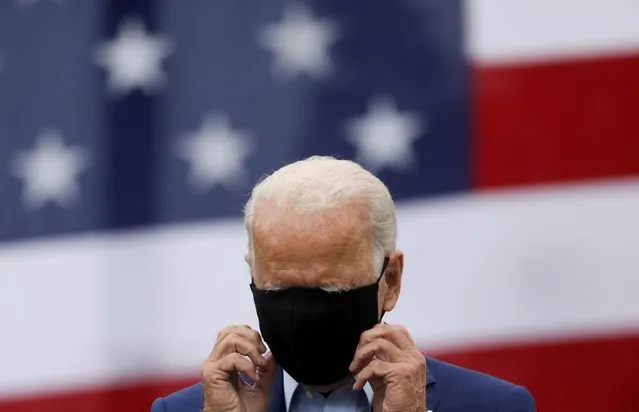 Democratic U.S. presidential nominee and former Vice President Joe Biden adjusts his protective face mask as he speaks during a campaign stop in Warren, Michigan, U.S., September 9, 2020. (Photo by Leah Millis/Reuters)