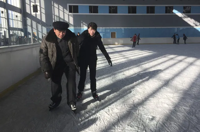 In this Thursday, February 1, 2018, photo, a couple enjoy ice skating at the Outdoor Skating Rink in Pyongyang, North Korea. Though not known as a winter sports power, North Korea will be joining in the Pyeongchang Games set to begin on Feb. 9. (Photo by Eric Talmadge/AP Photo)