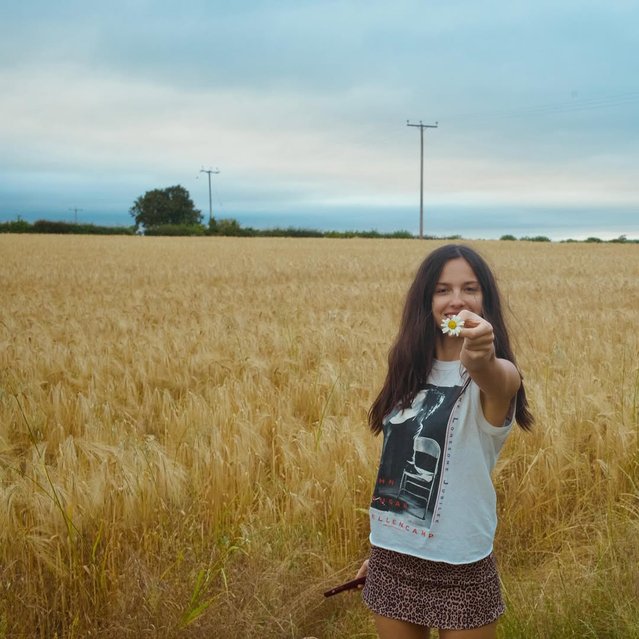American singer-songwriter and actress Olivia Rodrigo takes some time to pick the flowers after performing at Glastonbury in the last decade of June 2025. (Photo by Olivia Rogrido/Instagram)