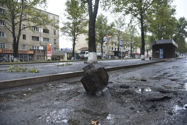 An unexploded projectile of a multiple rocket launcher stuck in a street after shelling by Azerbaijan's artillery during a military conflict in Stepanakert, self-proclaimed Republic of Nagorno-Karabakh, Azerbaijan, Monday, October 5, 2020. Armenia accused Azerbaijan of firing missiles into the capital of the separatist territory of Nagorno-Karabakh, while Azerbaijan said several of its towns and its second-largest city were attacked. (Photo by David Ghahramanyan/NKR InfoCenter PAN Photo via AP Photo)