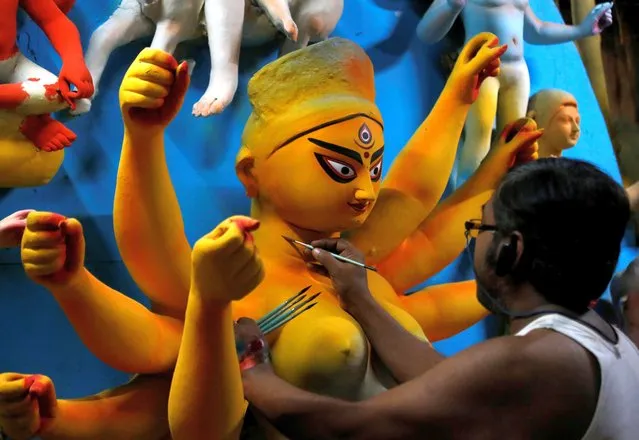An artisan paints an idol of Hindu goddess Durga at a workshop ahead of the Durga Puja festival, amidst the spread of the coronavirus disease (COVID-19), in Kolkata, India, October 15, 2020. (Photo by Rupak De Chowdhuri/Reuters)