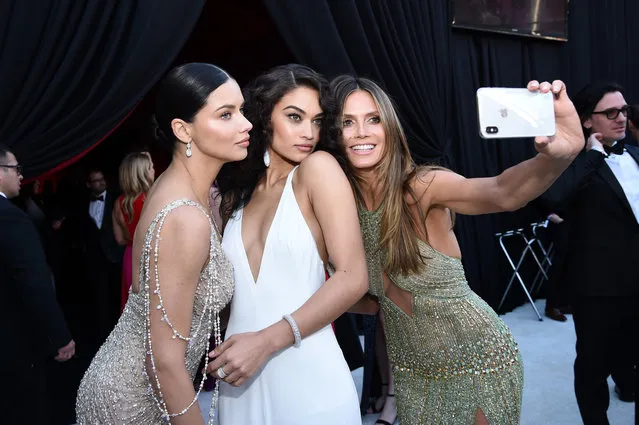 (L-R) Adriana Lima, Shanina Shaik,  Heidi Klum  attends the 26th annual Elton John AIDS Foundation Academy Awards Viewing Party sponsored by Bulgari, celebrating EJAF and the 90th Academy Awards at The City of West Hollywood Park on March 4, 2018 in West Hollywood, California. (Photo by Dimitrios Kambouris/Getty Images for EJAF)