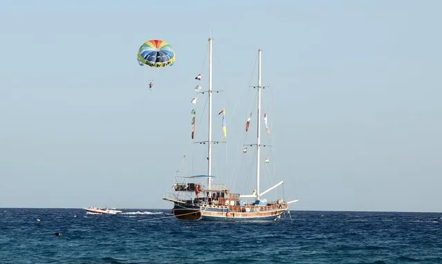 A tourist parasails over the sea in the Red Sea resort of Sharm el-Sheikh, November 7, 2015. (Photo by Asmaa Waguih/Reuters)