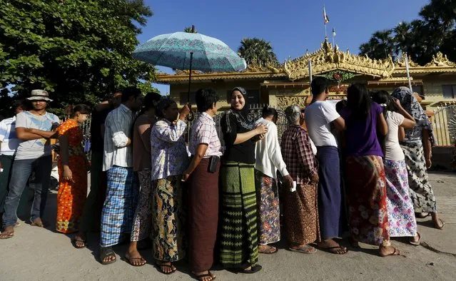 A muslim voter lines up to vote in a Buddhist prayer hall during the general election in Mandalay, Myanmar, November 8, 2015. (Photo by Olivia Harris/Reuters)