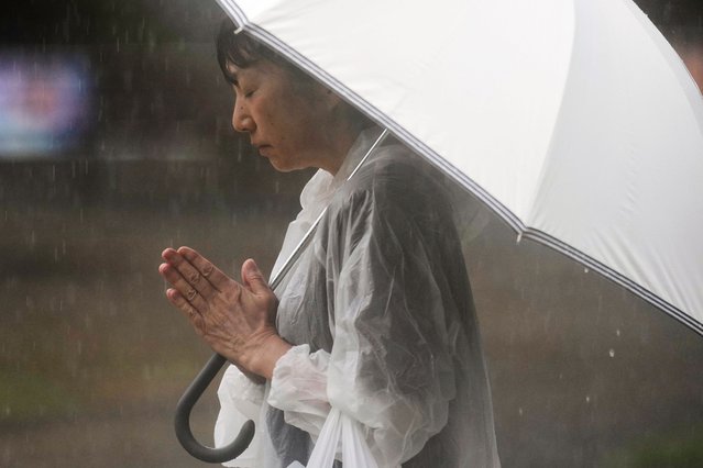 A person prays ahead of a ceremony to mark the 80th anniversary of the WWII U.S. atomic bombing at Atomic Bomb Hypocenter Park in Nagasaki, Japan, August 9, 2025. (Photo by Eugene Hoshiko/AP Photo)