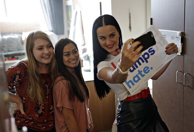 Singer Katy Perry takes a selfie with students while canvassing for Democratic presidential nominee Hillary Clinton in a dorm at UNLV, Saturday, October 22, 2016, in Las Vegas. (Photo by John Locher/AP Photo)