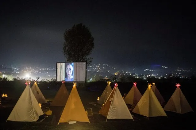 People watch movies from tents placed for social distancing at the campsites in Bandung, West Java Province, Indonesia on December 1, 2020. (Photo by M. Agung Rajasa/Antara Foto via Reuters)