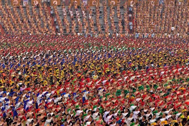 Participants wearing colourful attire perform Bihu dance, a traditional folk dance, to try and set a Guinness World Record for the largest Bihu dance performance in the world at a single venue, in Guwahati, India on April 13, 2023. (Photo by Anuwar Hazari/Reuters)