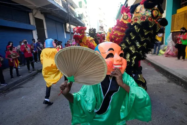 Lion dancers perform in the streets of Chinatown to celebrate the Chinese Lunar New Year of the Tiger in Panama City, Tuesday, February 1, 2022. (Photo by Arnulfo Franco/AP Photo)