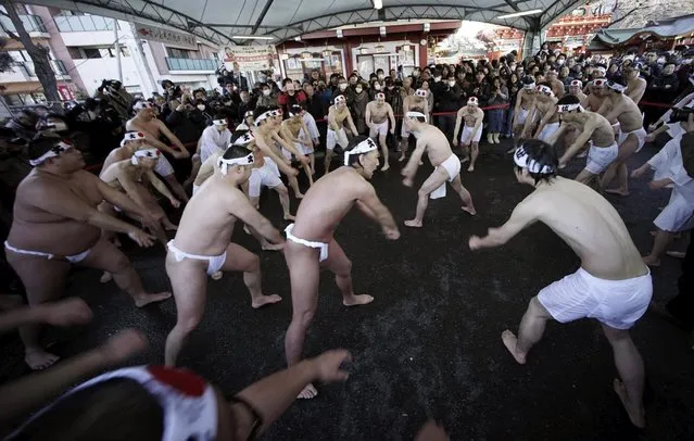Shrine parishioners perform the ritual ceremony after pouring cold water onto themselves during an annual cold-endurance festival at the Kanda Myojin Shinto shrine in Tokyo, Saturday, January 10, 2015. (Photo by Eugene Hoshiko/AP Photo)