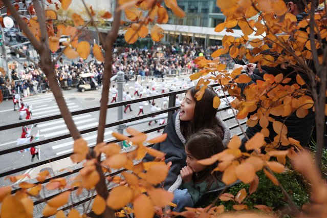 Spectators watch the Macy's Thanksgiving Day Parade as it marches down Sixth Avenue in New York, November 27, 2025. (Photo by Heather Khalifa/AP Photo)