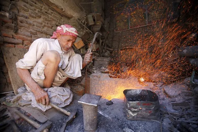 A man works in his shop at a market place in the old quarter in the Yemeni capital Sanaa, December 3, 2015. (Photo by Mohamed al-Sayaghi/Reuters)