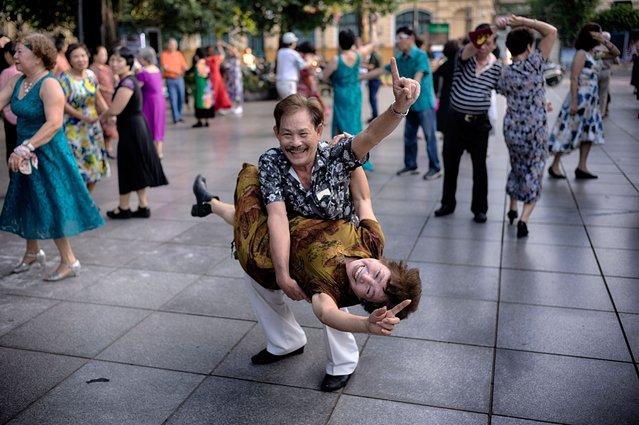A Vietnamese couple practices Ballroom dancing as part of their morning exercise along Hoan Kiem Lake in Hanoi, Vietnam, May 2, 2025. (Photo by Richard Vogel/AP Photo)
