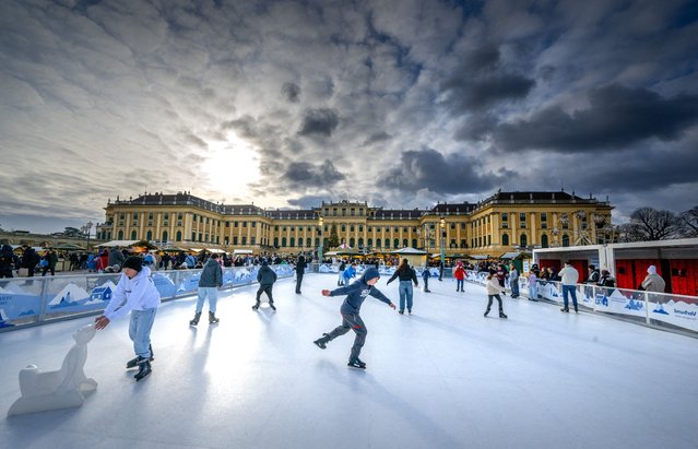 Children enjoy skating at the ice rink built at the Christmas market outside of the Schoenbrunn imperial palace just few days before Christmas in Vienna, Austria on December 20, 2024. Schoenbrunn Palace was the main summer residence of the Habsburg rulers. (Photo by Joe Klamar/AFP Photo)