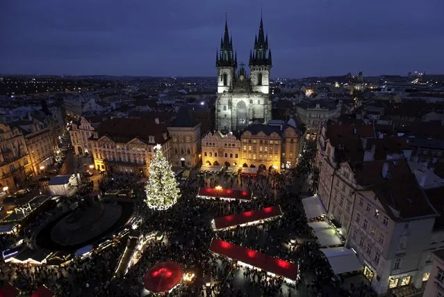 A Christmas tree is illuminated as the traditional Christmas market opens at the Old Town Square in Prague, Czech Republic, November 28, 2015. (Photo by David W. Cerny/Reuters)