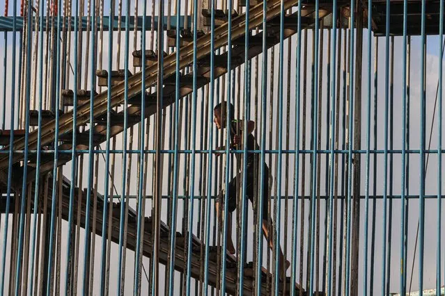 A Palestinian youth climbs stairs at an amusement park on the outskirts of Khan Yunis in the southern Gaza Strip on  June 30, 2023, on the third day of the Muslim holiday of Eid al-Adha. (Photo by Said Khatib/AFP Photo)