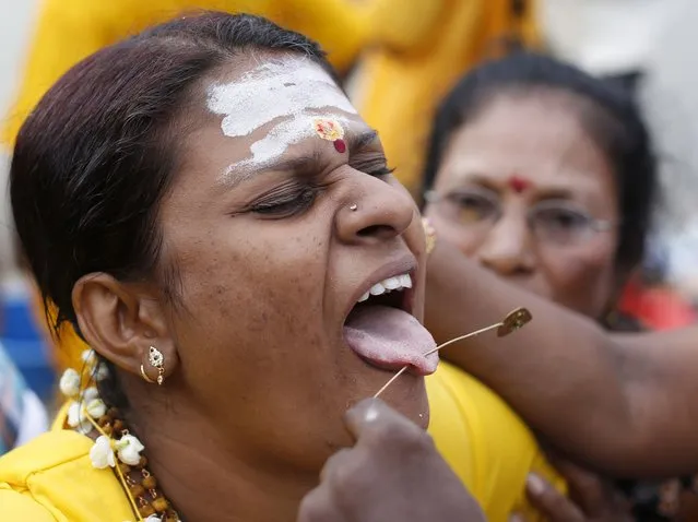 A Hindu devotee has her tongue pierced before her pilgrimage to the Batu Caves temple during Thaipusam in Kuala Lumpur February 3, 2015. (Photo by Olivia Harris/Reuters)
