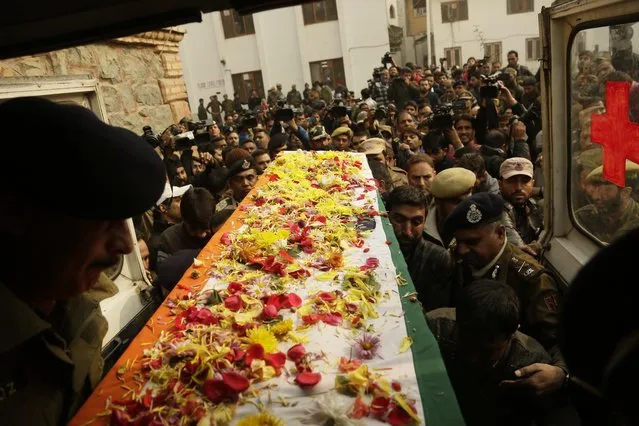 Indian police officers carry the coffin of their colleague who was killed in a shootout, at the police headquarters in Srinagar, Indian controlled Kashmir, Wednesday, November 16, 2016. Policeman Mohd Shafi Dar was killed early Wednesday in a shootout with suspected militants in Sopore, according to media reports. (Photo by Mukhtar Khan/AP Photo)