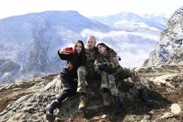 This photo provided by Azerbaijan's Presidential Press Office on Saturday, March 20, 2021, Azerbaijani President Ilham Aliyev, his wife and Azerbaijan's Vice President Mehriban Aliyeva, right, and his daughter Leyla Aliyeva pose for a selfie while celebrating Novruz Bayramı, a traditional holiday which celebrates the New Year and the coming of Spring in Shusha, Azerbaijan. Aliyev marked the Nowruz holiday by lighting a ceremonial fire outside Shusha, a culturally revered city that Azerbaijan took from Armenian forces in last autumn's war. Shusha, a center of Azeri culture for centuries, came under Armenian control in 1992 in fighting over the separatist Nagorno-Karabakh region. (Photo by Vugar Amrullaev/Azerbaijani Presidential Press Office via AP Photo)