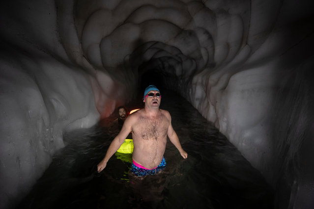 Ice swimmers Johannes (R) and Gerhard (L) prepare to swim in a filled up water kettle in an ice cave inside the Nature Ice Palace, with a hight of 3,250 meters (10,663 feet) above sea level, at Hintertux Glacier near Hintertux, some 480 kilometers (298 miles) western of Vienna, Austria, 27 July 2018. (Photo by Christian Bruna/EPA/EFE)