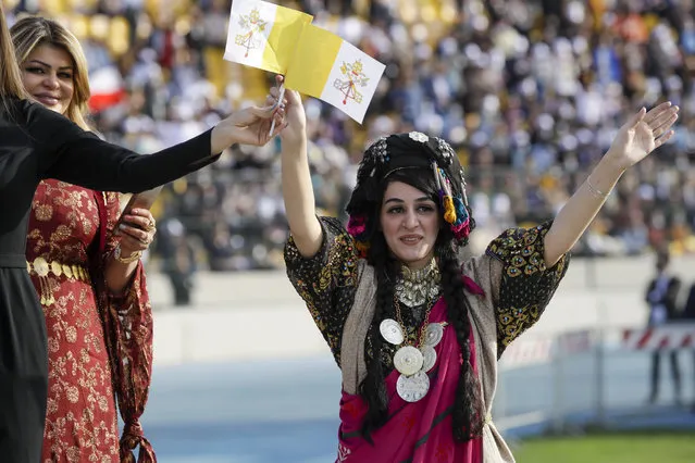 People wait for Pope Francis to celebrate mass at the Franso Hariri Stadium in Irbil, Kurdistan Region of Iraq, Sunday, March 7, 2021. The Vatican and the pope have frequently insisted on the need to preserve Iraq's ancient Christian communities and create the security, economic and social conditions for those who have left to return. (Photo by Andrew Medichini/AP Photo)